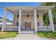 Charming two-story home featuring an inviting front porch with stately columns and a red door at 1842 Nebraska Ne Ave, St Petersburg, FL 33703