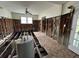 Living room renovation featuring exposed studs, subfloor, hot water tank, and window views at 1842 Nebraska Ne Ave, St Petersburg, FL 33703