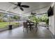 Enclosed patio with dining table and chairs, ceiling fans, and view of backyard at 1842 Nebraska Ne Ave, St Petersburg, FL 33703
