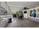 Enclosed patio with a tv, ceiling fans, dining set, and view of the pool and backyard at 1842 Nebraska Ne Ave, St Petersburg, FL 33703