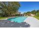 Spacious pool in the backyard with an adjacent patio area and lush, mature landscaping at 1842 Nebraska Ne Ave, St Petersburg, FL 33703