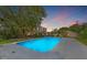 Large in-ground pool with ample patio space on a sprawling lot with mature trees and picturesque sunset skies at 1842 Nebraska Ne Ave, St Petersburg, FL 33703
