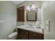 Bathroom features a dark wood vanity, white countertop, and a framed mirror at 1916 38Th W St, Bradenton, FL 34205