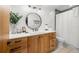 Bright bathroom features shiplap walls, wood vanity, and a round mirror at 1916 38Th W St, Bradenton, FL 34205