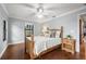 Inviting bedroom with wooden bed, hardwood floors, ceiling fan, and natural light at 1916 38Th W St, Bradenton, FL 34205