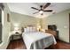 Bedroom features hardwood floors, a ceiling fan, and a comfortable bed at 1916 38Th W St, Bradenton, FL 34205