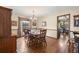 Formal dining room featuring hardwood floors, large windows, and elegant chandelier lighting at 1916 38Th W St, Bradenton, FL 34205