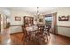 Traditional dining room with hardwood floors, chandelier, china cabinet, and window at 1916 38Th W St, Bradenton, FL 34205
