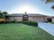 Charming single-story home featuring a well-manicured lawn, mature landscaping, and an attached garage at 1916 38Th W St, Bradenton, FL 34205