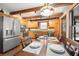Country kitchen featuring wooden cabinets, updated appliances, and a rustic dining table at 1916 38Th W St, Bradenton, FL 34205