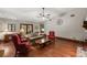 Open-concept living area with hardwood floors, a ceiling fan, and ample natural light at 1916 38Th W St, Bradenton, FL 34205