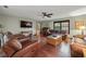 Comfortable living room with hardwood floors, leather furniture, ceiling fan, and natural light at 1916 38Th W St, Bradenton, FL 34205