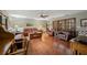 Spacious living room featuring hardwood floors, leather furniture, and sliding glass doors at 1916 38Th W St, Bradenton, FL 34205