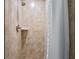 Tiled shower with a shower curtain and sleek fixtures in a modern bathroom at 1916 38Th W St, Bradenton, FL 34205