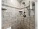 Modern shower with tile walls, rainfall showerhead, and handheld sprayer at 1916 38Th W St, Bradenton, FL 34205