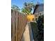 Narrow grassy side yard with a wooden fence and walkway at 1916 38Th W St, Bradenton, FL 34205