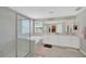 Bright bathroom with double vanity, soaking tub, walk-in shower, and large mirror at 19592 Breynia Dr, Lutz, FL 33558