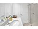 Bright bathroom featuring a modern vanity, quartz countertop, and glass-enclosed shower at 19592 Breynia Dr, Lutz, FL 33558