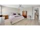 Cozy bedroom with a ceiling fan, wood-look floors, and neutral paint colors at 19592 Breynia Dr, Lutz, FL 33558