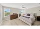Bright bedroom with natural light and a cozy bed near windows overlooking the lake at 19592 Breynia Dr, Lutz, FL 33558
