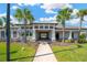 Clubhouse entrance framed by palm trees, offering a welcoming and sophisticated community hub at 19592 Breynia Dr, Lutz, FL 33558