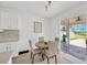 Cozy dining area with a view of the patio, featuring a table and chairs next to the kitchen at 19592 Breynia Dr, Lutz, FL 33558