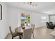Dining area with tile floors, a modern chandelier and a glass sliding door that leads to the backyard at 19592 Breynia Dr, Lutz, FL 33558