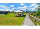 Community gazebo with picnic tables, playground, and lush green spaces for outdoor enjoyment at 19592 Breynia Dr, Lutz, FL 33558