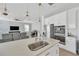 Open-concept kitchen with island sink, modern appliances, pendant lighting, and seamless living space at 19592 Breynia Dr, Lutz, FL 33558