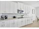 Kitchen with white cabinetry, stainless appliances, and tile backsplash at 19592 Breynia Dr, Lutz, FL 33558