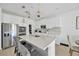 Kitchen island with pendant lighting and stainless steel appliances at 19592 Breynia Dr, Lutz, FL 33558