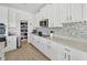 Bright kitchen with white cabinets, stainless steel appliances, subway tile backsplash, and counter space at 19592 Breynia Dr, Lutz, FL 33558