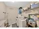 Functional laundry room with washer, dryer, and storage shelves for organization at 19592 Breynia Dr, Lutz, FL 33558