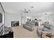 Open concept living room features a piano and view of the kitchen at 19592 Breynia Dr, Lutz, FL 33558