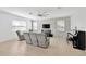 Inviting living room featuring modern furniture, a stone accent wall, and tile flooring at 19592 Breynia Dr, Lutz, FL 33558