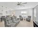 Living room with gray upholstered seating and view of the backyard at 19592 Breynia Dr, Lutz, FL 33558