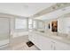 Luxurious bathroom with double vanity, soaking tub, walk-in closet, and glass shower at 19592 Breynia Dr, Lutz, FL 33558