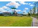 Community playground with slides, climbing structures, and plenty of space for recreational activities at 19592 Breynia Dr, Lutz, FL 33558