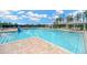 Community pool with blue water, lounge chairs, and a gazebo offering a resort-style living at 19592 Breynia Dr, Lutz, FL 33558