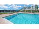 Community pool with blue water, lounge chairs, and a gazebo offering a resort-style living at 19592 Breynia Dr, Lutz, FL 33558
