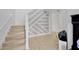 Elegant stairway featuring a gray and white wall design, hardwood floors, and sleek railing at 19592 Breynia Dr, Lutz, FL 33558
