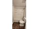 Clean bathroom with white fixtures, including a tub-shower combo, toilet and tile flooring at 1960 Lakewood Club Dr S # 2-F, St Petersburg, FL 33712