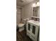 Well-lit bathroom featuring a vanity with storage, decorative fixtures, and updated flooring at 1960 Lakewood Club Dr S # 2-F, St Petersburg, FL 33712