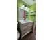 Bathroom vanity with a white framed mirror and modern lighting, plus modern light fixtures at 1960 Lakewood Club Dr S # 2-F, St Petersburg, FL 33712