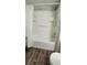 Bright bathroom with a white shower-tub and updated faucet fixtures, plus wood-look flooring at 1960 Lakewood Club Dr S # 2-F, St Petersburg, FL 33712
