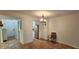 Dining area featuring tiled floors, a modern light fixture, and a view into the kitchen at 1960 Lakewood Club Dr S # 2-F, St Petersburg, FL 33712