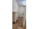 Clean hallway with neutral paint, tiled floor, and a modern storage cabinet near the entrance at 1960 Lakewood Club Dr S # 2-F, St Petersburg, FL 33712