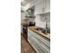 Modern kitchen with stainless steel appliances, white cabinets, and sleek butcher block countertops at 1960 Lakewood Club Dr S # 2-F, St Petersburg, FL 33712