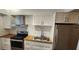 Updated kitchen featuring stainless steel appliances, white cabinets, and butcher block countertops at 1960 Lakewood Club Dr S # 2-F, St Petersburg, FL 33712