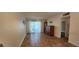 Open living room with tiled floors, natural light from sliding glass doors, and a classic wood cabinet at 1960 Lakewood Club Dr S # 2-F, St Petersburg, FL 33712
